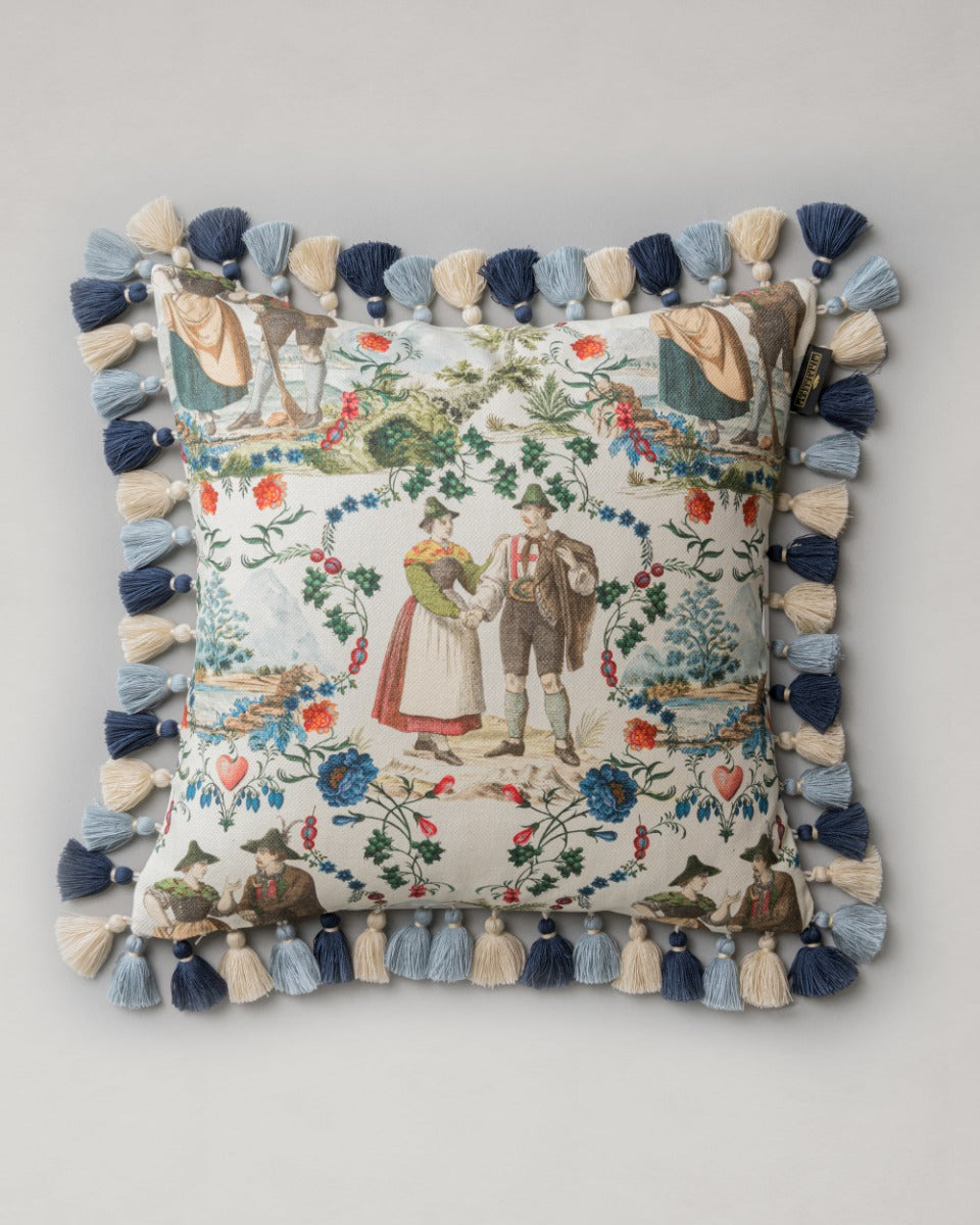 LANDHAUSMODE Cushion (LC40197) by Mind The Gap | LC40197 | TYROL APRES-SKI | 50 x 50 cm | Blue, White, Green, Red | Fringes all around | Duck feather | 56% Cotton, 44% Linen | Fabric Carolina | https://www.fabriccarolina.com/