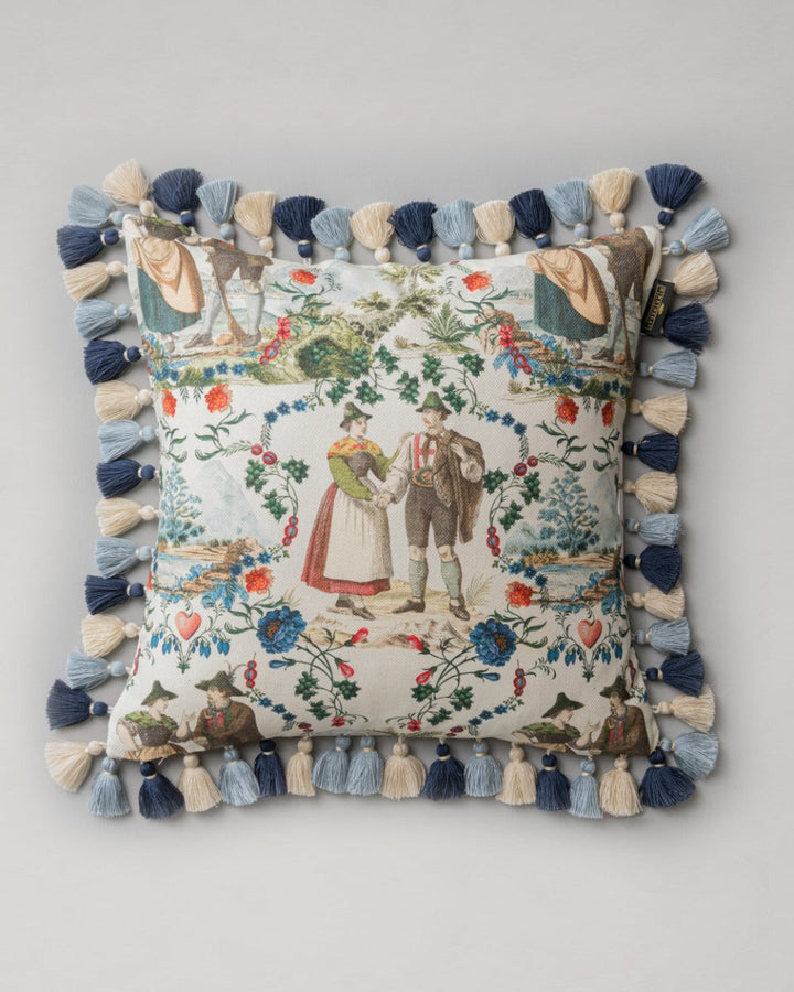 LANDHAUSMODE Cushion (LC40197) by Mind The Gap | LC40197 | TYROL APRES-SKI | 50 x 50 cm | Blue, White, Green, Red | Fringes all around | Duck feather | 56% Cotton, 44% Linen | Fabric Carolina | https://www.fabriccarolina.com/