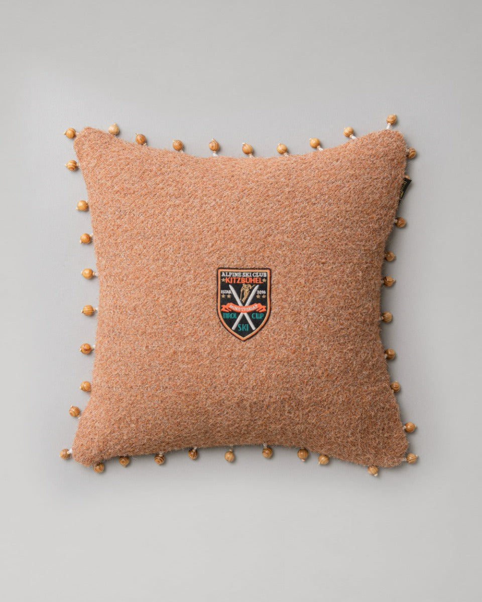 ALPINE SKI CLUB Cushion (LC40203) by Mind The Gap | LC40203 | TYROL APRES-SKI | 50 x 50 cm | Brown | Small wooden balls all around | Duck feather | 73% Polyester, 27% Jute | Fabric Carolina | https://www.fabriccarolina.com/