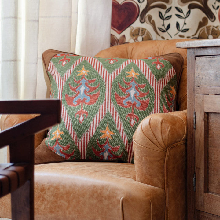 Tannenbaum Cushion by Mind the Gap Designer Pillow TYROL APRES-SKI HOME COLLECTION 46% Cotton, 40% Jute, 14% other fibres Made in Romania Leather piped edge and leather patches at each corner 20 x 20 in - Swanky Fabrics -